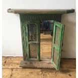 MIRROR PANEL IN DISTRESSED GREEN PAINTED WOODEN FRAME, protected with a pair of fret work panelled