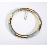 A 9ct GOLD MOUNTED JADE BANGLE