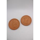 A PAIR OF DANISH CIRCULAR TERRACOTTA PLAQUES EMBOSSED WITH ROMAN SCENES, depicting hunter and