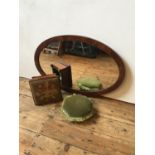 A MAHOGANY OVAL FRAMED WALL MIRROR AND TWO VICTORIAN UPHOLSTERED FOOT STOOLS, the mirror 97 x 60cms