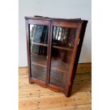 A STAINED PINE 2-DOOR GLAZED WALL MOUNTED CORNER DISPLAY CABINET, 85 x 66cms