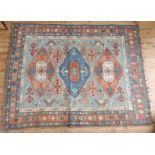 TURKISH BORDER PATTERN GEOMETRIC DESIGN RUG, red and fawn on a blue ground, 210 x 164cms