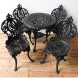 A HEAVY CAST-IRON ORNATE PIERCED PATIO TABLE AND FOUR MATCHING CHAIRS, the table with 'jubilee'