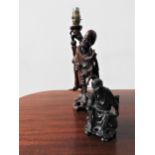 A CARVED CHINESE TABLE LAMP AND CARVED CHINESE FIGURE 20TH CENTURY modelled as Lohans