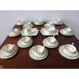 A CAULDRON LTD ROSE AND SWAG DECORATED 40-PIECE TEA SET (12 place settings), with gilded edge