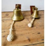 TWO BRASS WALL MOUNTED MARITIME-STYLE BELLS, 20cm dia and smaller