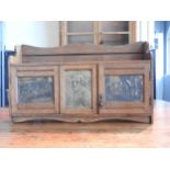 AN OAK FITTED TABLE TOP CABINET DECORATED WITH BRASS EMBOSSED PANELS DEPICTING SHAKESPEARE, two