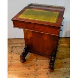 A VICTORIAN ROSEWOOD DAVENPORT WITH FOUR SIDE DRAWERS, FOUR FALSE DRAWERS AND PULL OUT STATIONERY