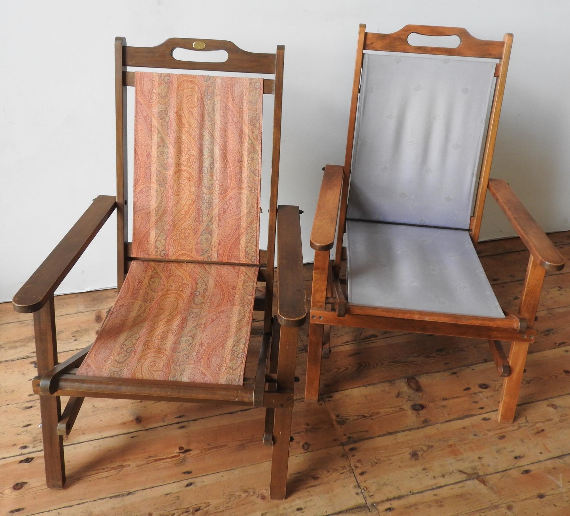 TWO FOLDING WOODEN PATIO CHAIRS WITH LOOSE CANVAS SEATS AND BACKS, ONE CHAIR BEARING A MULBERRY
