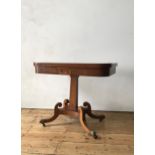A EARLY 19th CENTURY CROSSBANDED MAHOGANY CARD TABLE, on central tapered pedestal with carved