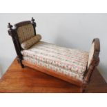 LOUIS XVI STYLE WALNUT AND UPHOLSTERED TOY BED LATE 19TH CENTURY covered in pink striped silk fabric
