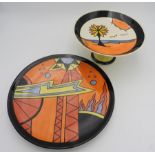 A SIGNED LORNA BAILEY GEOMETRIC CHARGER AND BEACH SCENE CAKE STAND, the charger stamped