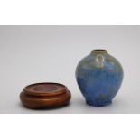 A SMALL POTTERY VASE WITH IRIDESCENT GLAZE BLOSSOM DECORATION, with an associated wooden stand,