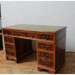 A YEW WOOD TWIN PEDESTAL LEATHER TOP WRITING DESK, three drawers over two banks of two, 74 x 125 x