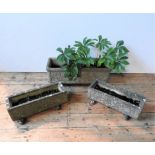 AN ORNATE WEATHERED GARDEN TROUGH AND TWO SMALLER TROUGHS, planted with Hellebore