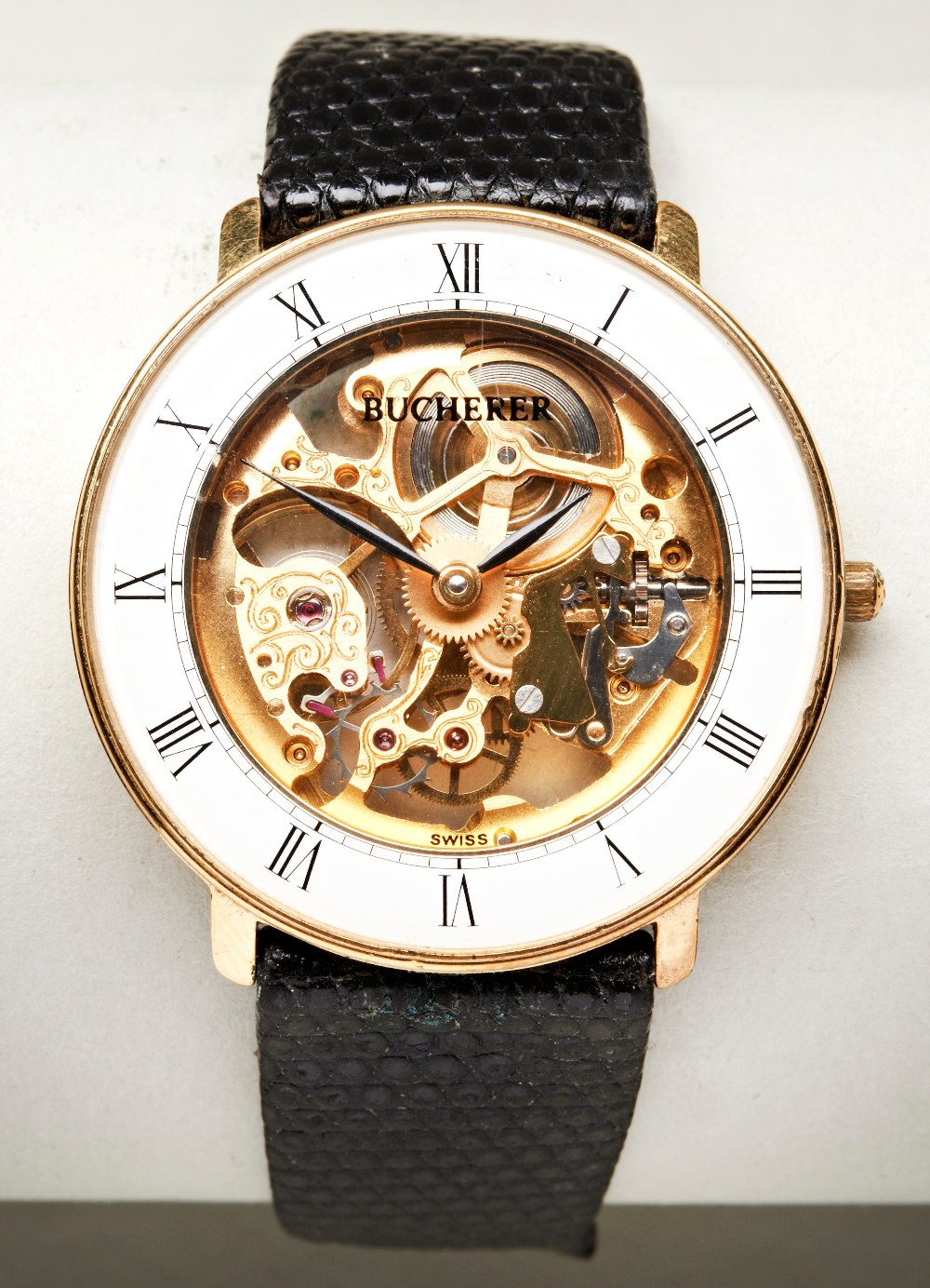 BUCHERER GOLD PLATED MANUAL WIND SKELETON WATCH, the white chapter ring with Roman numerals