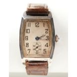 SWISS SILVER TONNEAU SHAPED MANUAL WRISTWATCH, c1915, the ?silver? dial with Arabic numerals, the