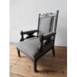 A VICTORIAN MAHOGANY NURSING CHAIR ON TURNED LEGS, with upholstered seat, back panel and arm