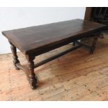 A 19TH CENTURY FRENCH OAK FARMHOUSE TABLE ON TURNED LEGS, on shaped stretcher bar support with