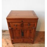 AN ORIENTAL STYLE HARDWOOD TWO DOOR CUPBOARD, with two drawers, 86 x 64 x 50cm