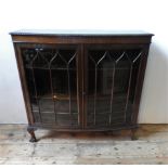 AN EARLY 20TH CENTURY BOW FRONT GLAZED DISPLAY CABINET