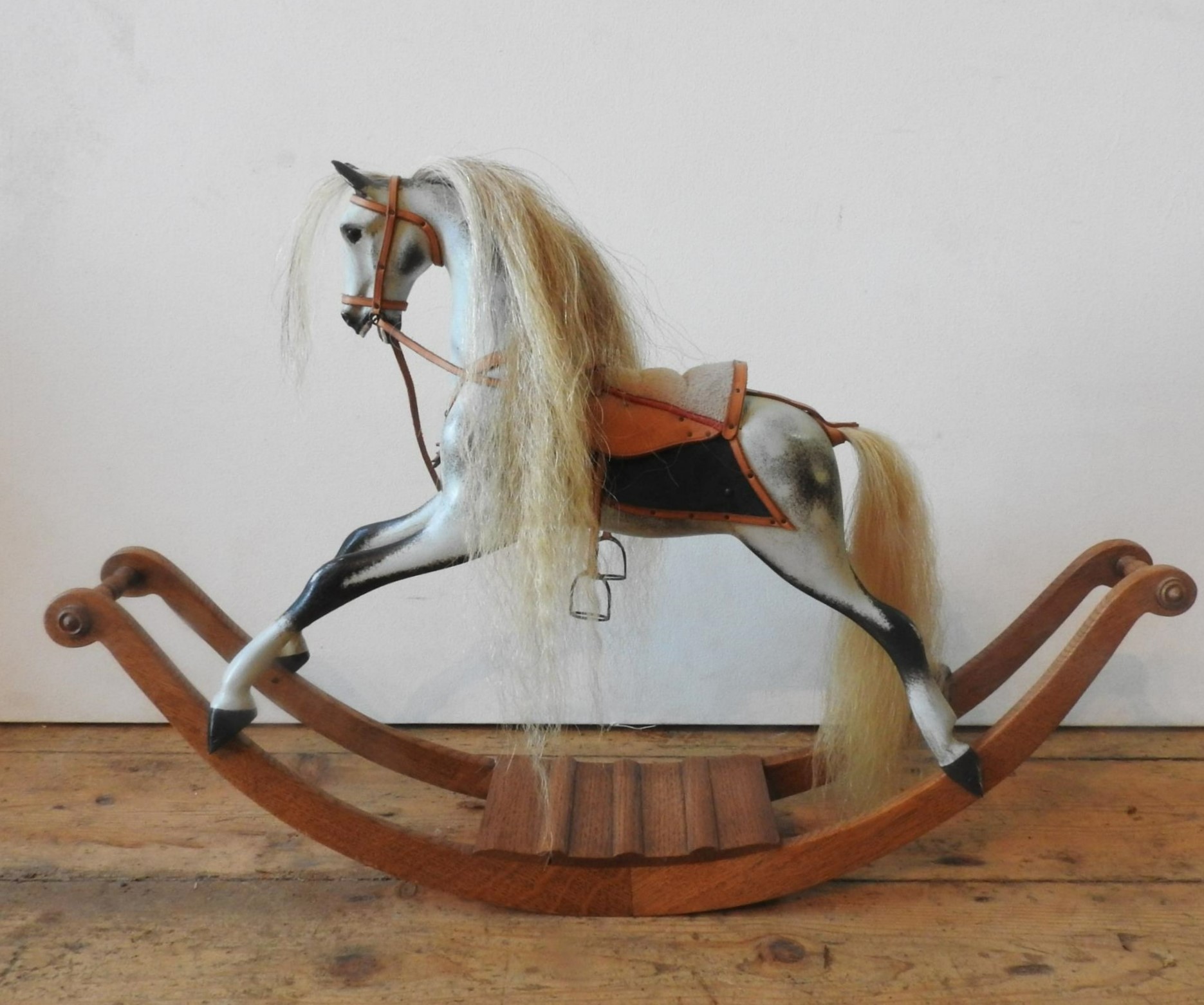 A STEVENSON BROS. MINIATURE MODEL ROCKING HORSE, in dappled grey and black colours with brass