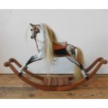 A STEVENSON BROS. MINIATURE MODEL ROCKING HORSE, in dappled grey and black colours with brass