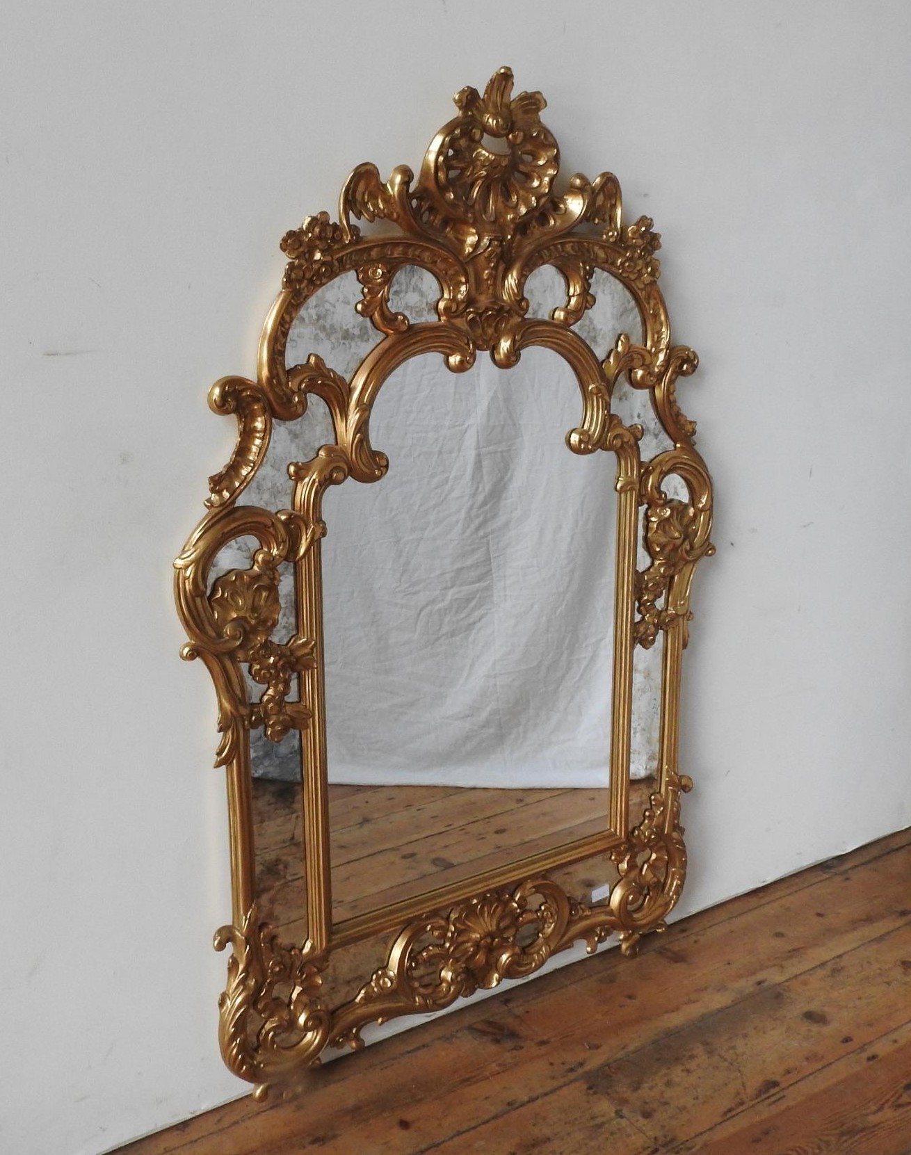 AN ORNATE CONTEMPORARY ROCOCO-STYLE GILT FRAMED WALL MIRROR, 145 x 95 cm