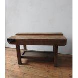 A VINTAGE WORKSHOP BENCH, on a pine base with shelf below and bench vice attached, 66 x 122 x 62cm