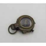 A BRASS FIRST WORLD WAR COMPASS, inscribed on the reverse F-L, No.121057, 1918, 5 cm dia