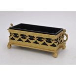 AN EBONY OBLONG BOX IN AN ORNATE GILDED METAL STAND, the stand with swag decoration, two foliate