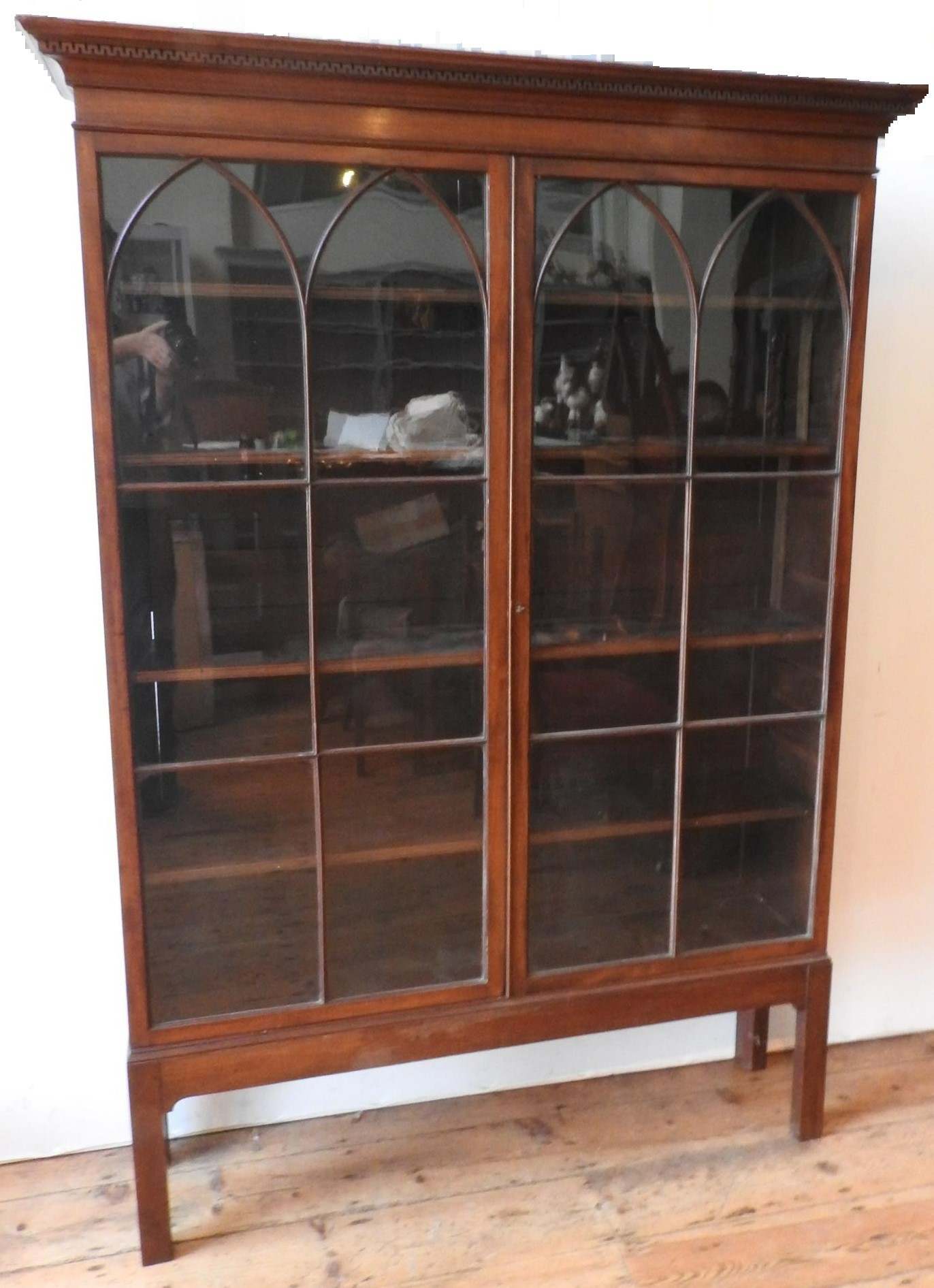 A GEORGE III MAHOGANY GLAZED TWO DOOR DISPLAY CABINET ,on square legs with narrow Grecian style