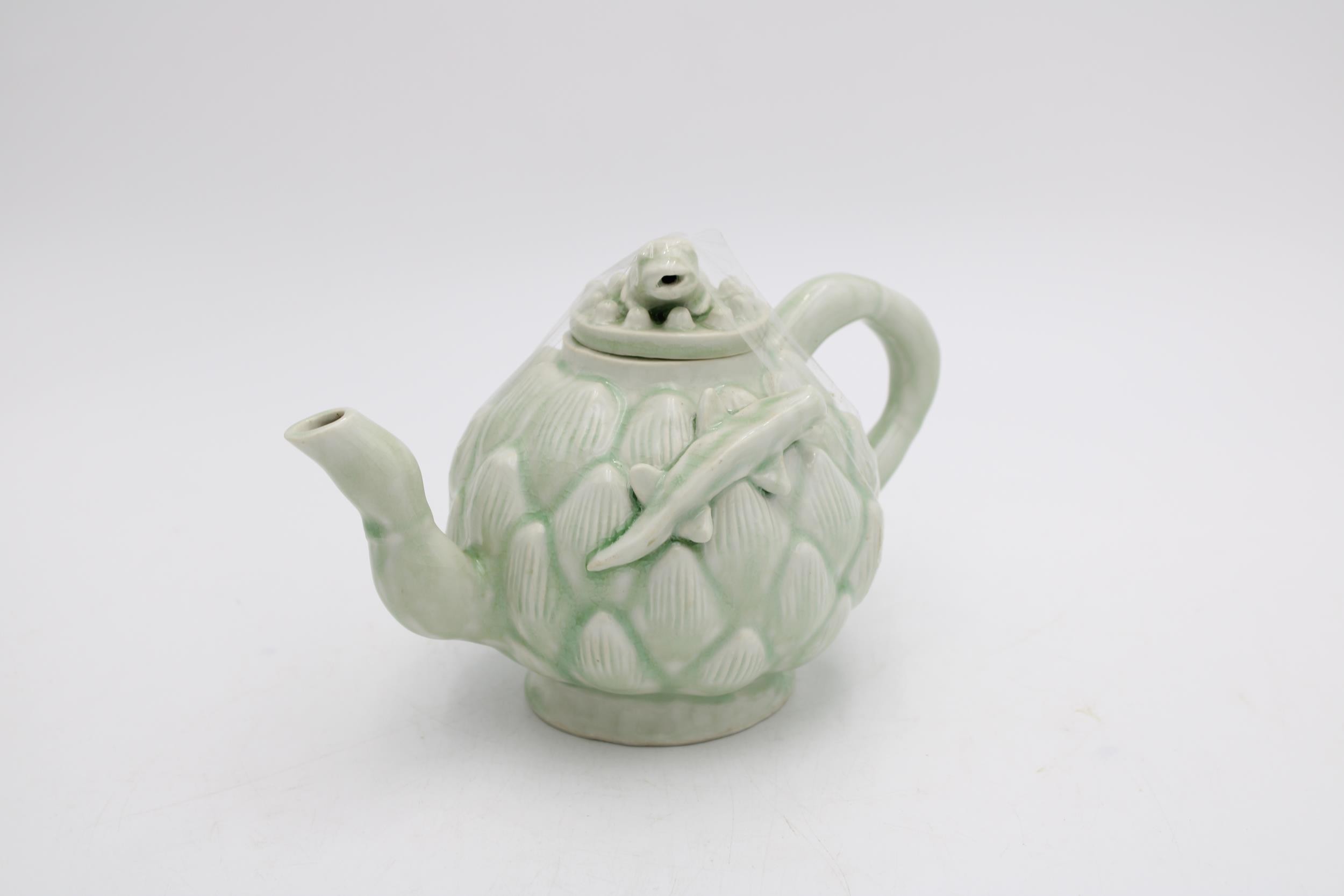 A CELADON GLAZE LOTUS TEAPOT WITH FROG AND NEWT DECORATION, 14cm high