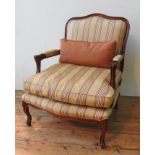 A WADE UPHOLSTERY 'RIMINI' ARMCHAIR AND FOOTSTOOL, both upholstered in gold and burgundy pinstripe