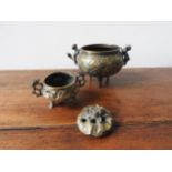TWO BRONZE CENSERS, the larger with two handles in the form of lions, the smaller in the form of a