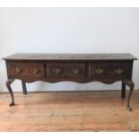 AN EARLY 19th CENTURY OAK THREE DRAWER DRESSER BASE, on Queen Anne front legs, the drawers with