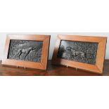 A PAIR OF EMBOSSED BRONZE PANELS DEPICTING POINTER DOGS, in oak frames, 18 x 33 cm