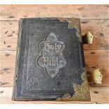 AN EARLY 20th CENTURY LEATHER AND BRASS BOUND FAMILY BIBLE, 27 X 33cm