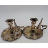 A PAIR OF SILVER PLATED ADJUSTABLE CHAMBER STICKS WITH CANDLE SNUFFERS, the bases in a tudor rose