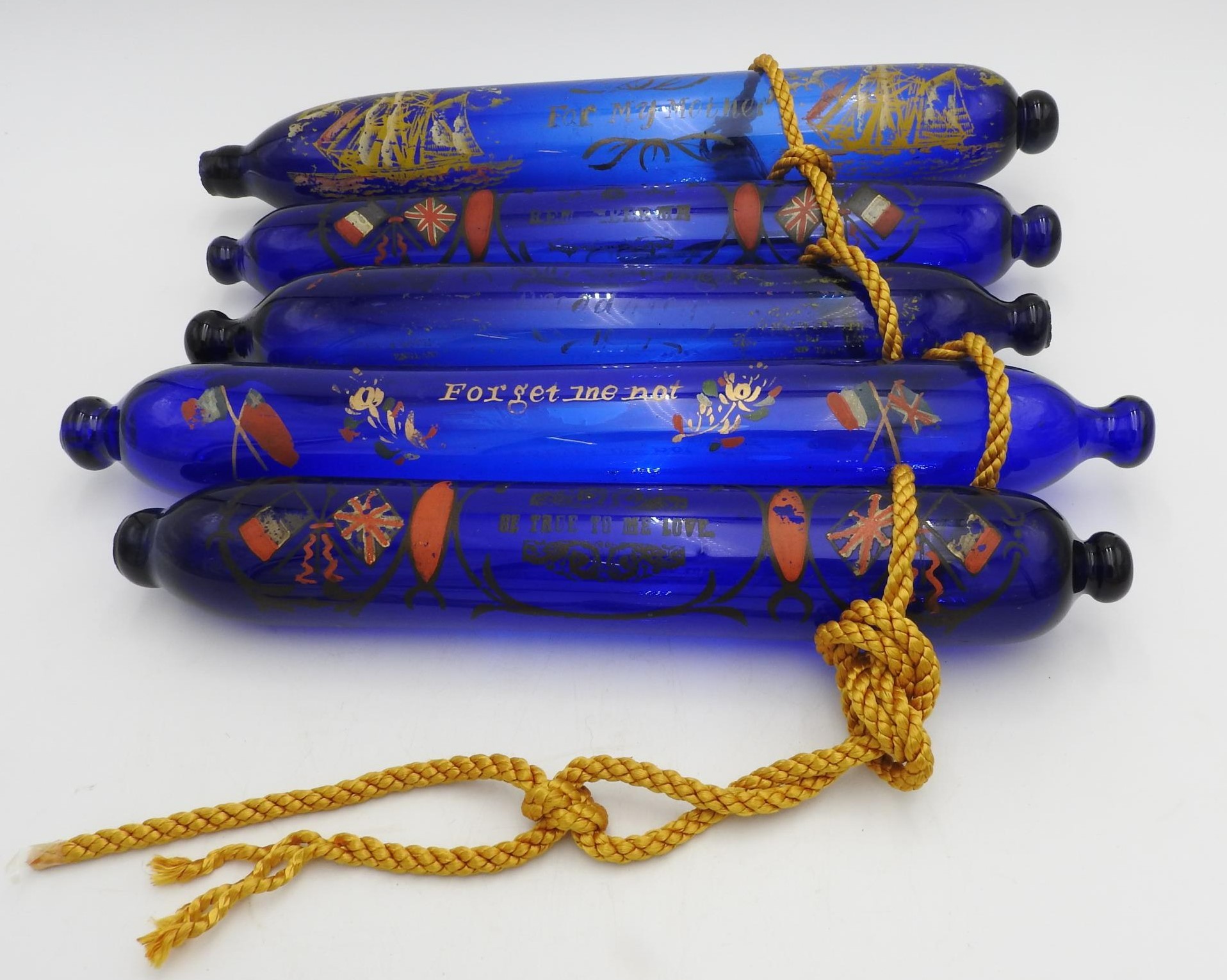 FIVE EARLY 19TH CENTURY COMMEMORATIVE BRISTOL COBALT BLUE GLASS NAVAL ROLLING PINS, 33 cm long