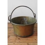 A CONTINENTAL RIVETED BRASS BUCKET WITH IRON RING HANDLE, 52cm dia