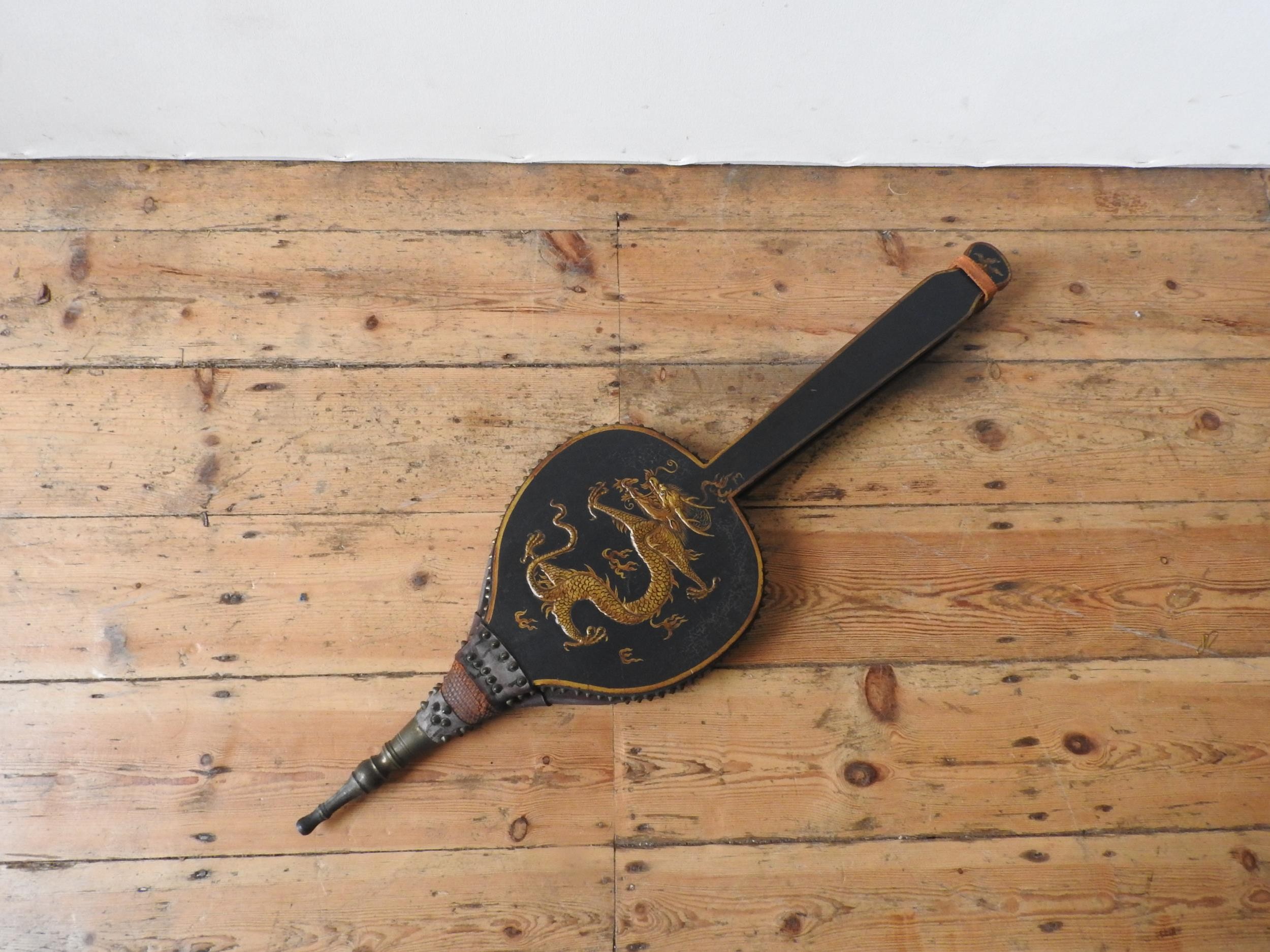 A PAIR OF 19TH CENTURY LONG HANDLED JAPANNED BELLOWS, painted with embossed dragon decoration, 97 cm