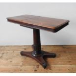 A VICTORIAN MAHOGANY TABLE WITH TWO WRITING SLOPE SECTIONS, on a tulip carved pedestal with an X-
