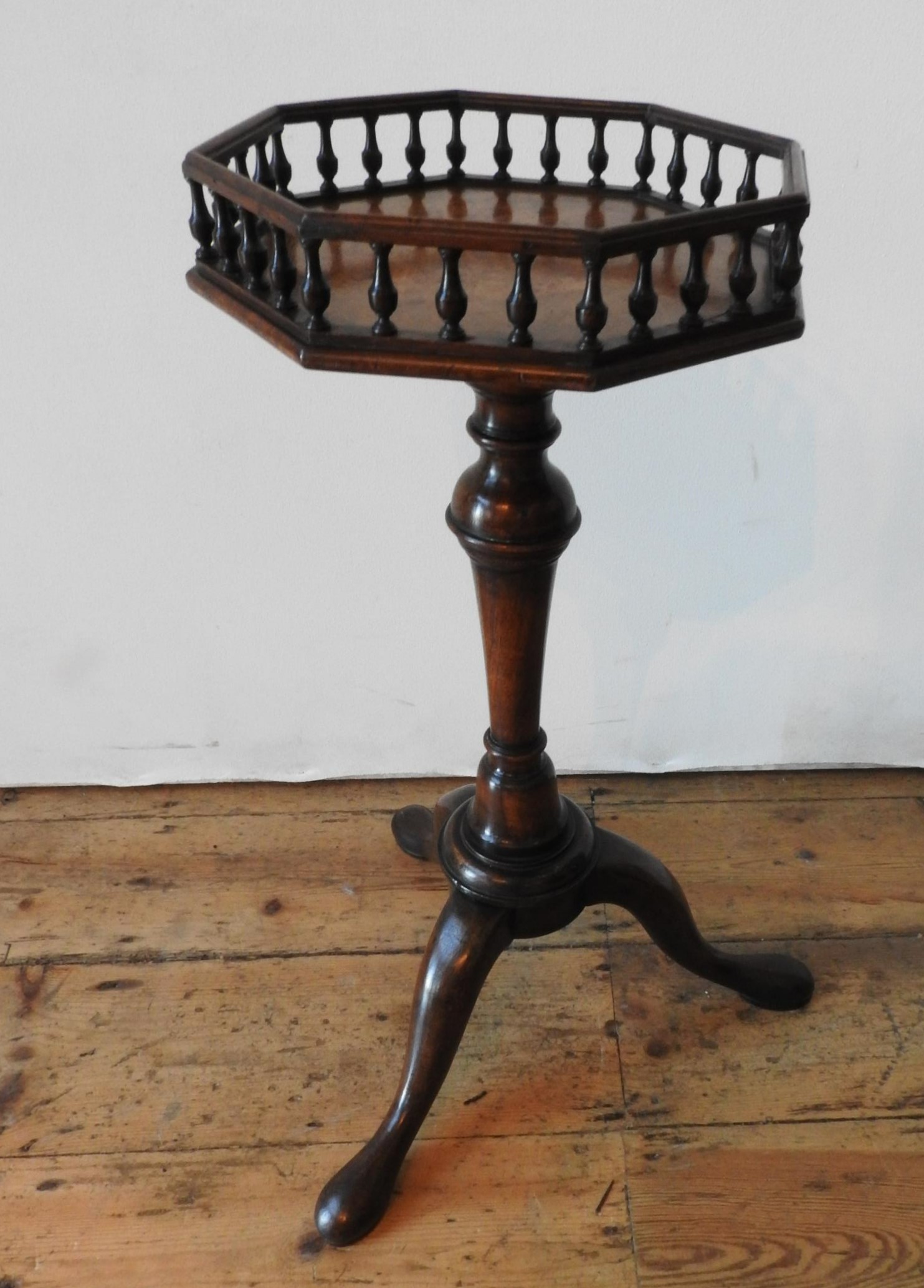 A 19TH CENTURY WALNUT TRIPOD TABLE WITH GALLERY EDGED OCTAGONAL TOP, with a tapered turned