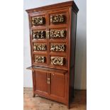 AN ANGLO-CHINESE ROSEWOOD DRINKS CABINET, with eight carved gilded panels, top cupboard contains