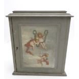A PAINTED OAK TABLE TOP TRINKET CABINET WITH SIX DRAWERS, enclosed by a door with a cherub