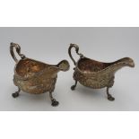 A PAIR OF LARGE IRISH HALLMARK SILVER SAUCEBOATS, with extensive foliate and bird embossed