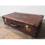 A VINTAGE LEATHER SUITCASE, with brass catches, canvas lined interior, monogrammed T.M.D.S, 23 x