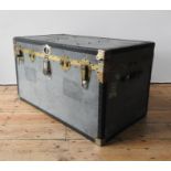 A TIN COVERED VINTAGE TRAVEL TRUNK, with two handles, latches and vintage air travel labels