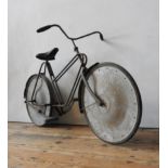 A RARE VINTAGE CHILDREN'S BICYCLE WITH CRANK PEDALS AND SOLID DISC WHEELS